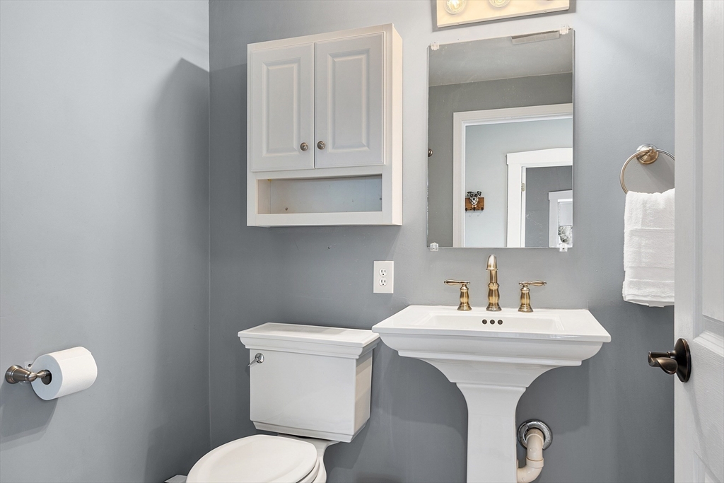 102 Centre Street Danvers, MA 01923 - Photo 17 of 36 a bathroom with a toilet sink and mirror