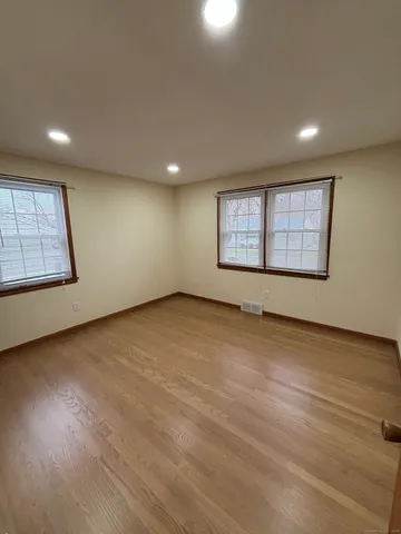 an empty room with a empty space and windows