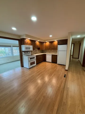 an open kitchen with a sink and dishwasher a oven with wooden floor