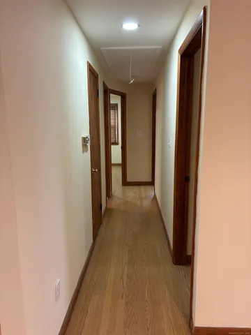 a view of a hallway with wooden floor