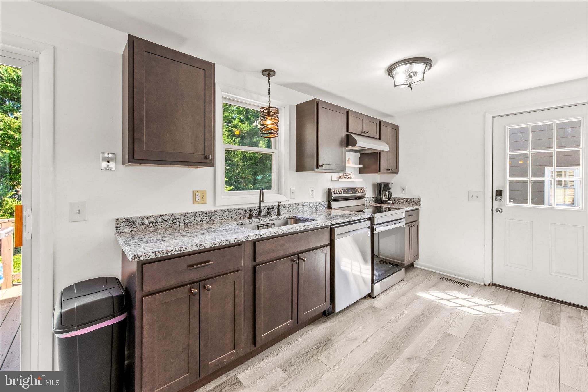21406 Dogwood Cove Road Tilghman, MD 21671 - Photo 26 of 68 a kitchen with a sink stove and microwave