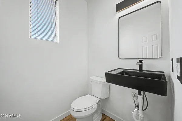 a bathroom with a toilet sink and mirror