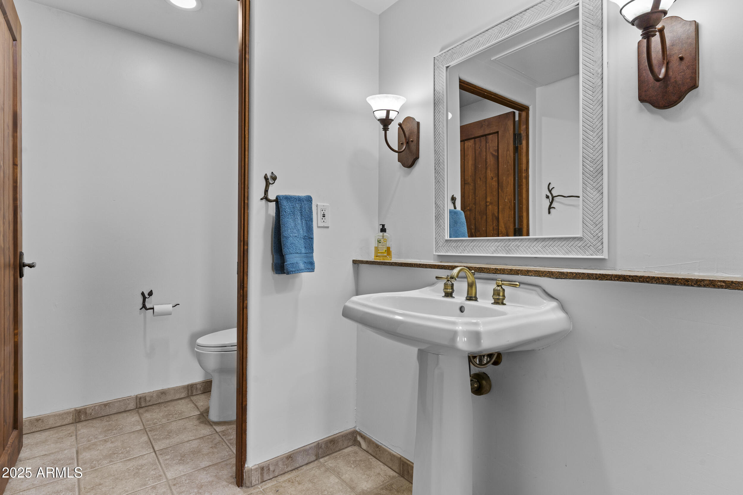 36601 North Mule Train Road, Unit D18 Carefree, AZ 85377 - Photo 29 of 57 a bathroom with a sink and a mirror