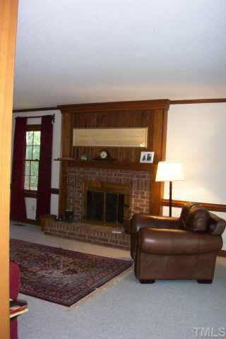 11945 Appaloosa Raleigh, NC 27613 - Photo 8 of 10 a living room with furniture and a fireplace