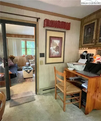 a view of a livingroom with furniture and a window