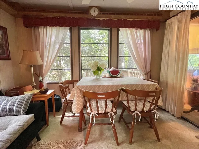 a dining room with furniture and window