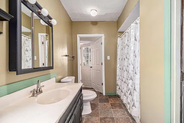 a bathroom with a double vanity sink toilet and shower