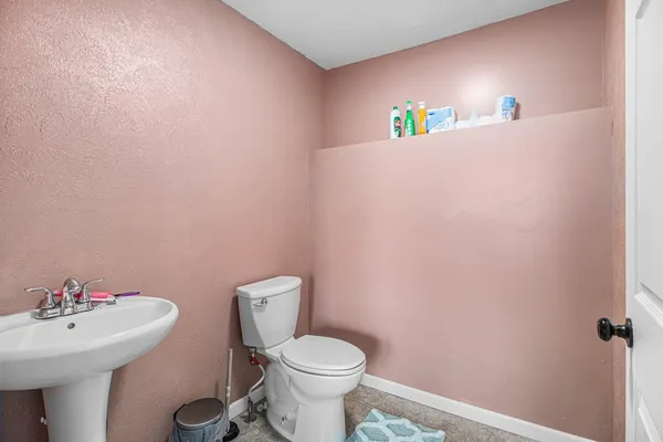 a bathroom with a sink a toilet and a mirror