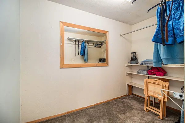 a bedroom with a bed and a bookshelf