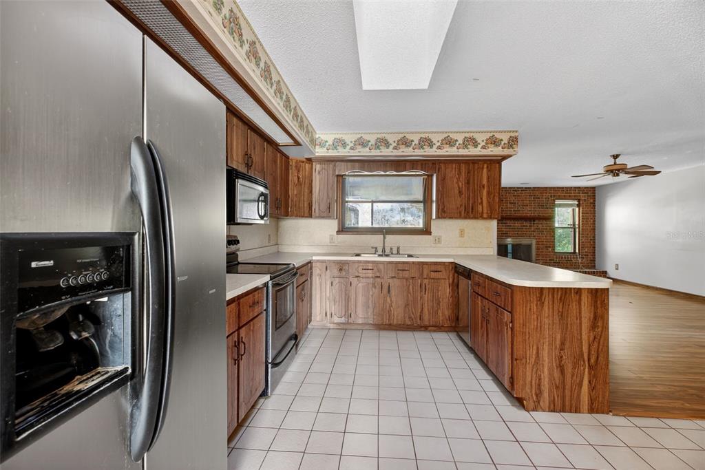 1620 Timbercrest Drive Deltona, FL 32738 - Photo 11 of 28 a kitchen with stainless steel appliances granite countertop a refrigerator and a stove