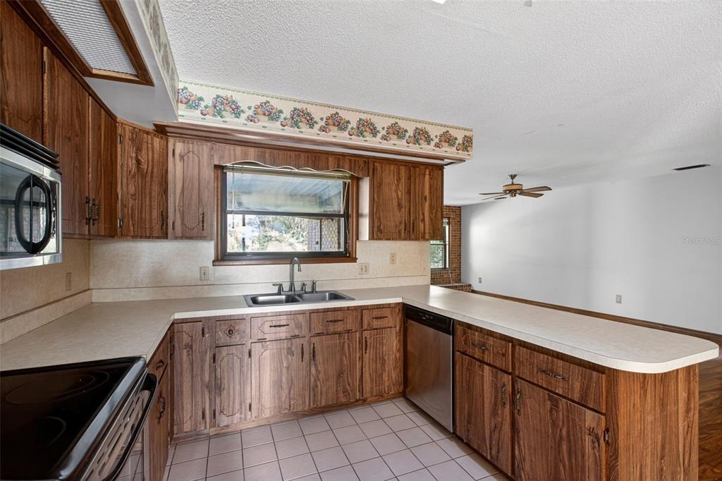 1620 Timbercrest Drive Deltona, FL 32738 - Photo 15 of 28 a kitchen with a sink stove and cabinets