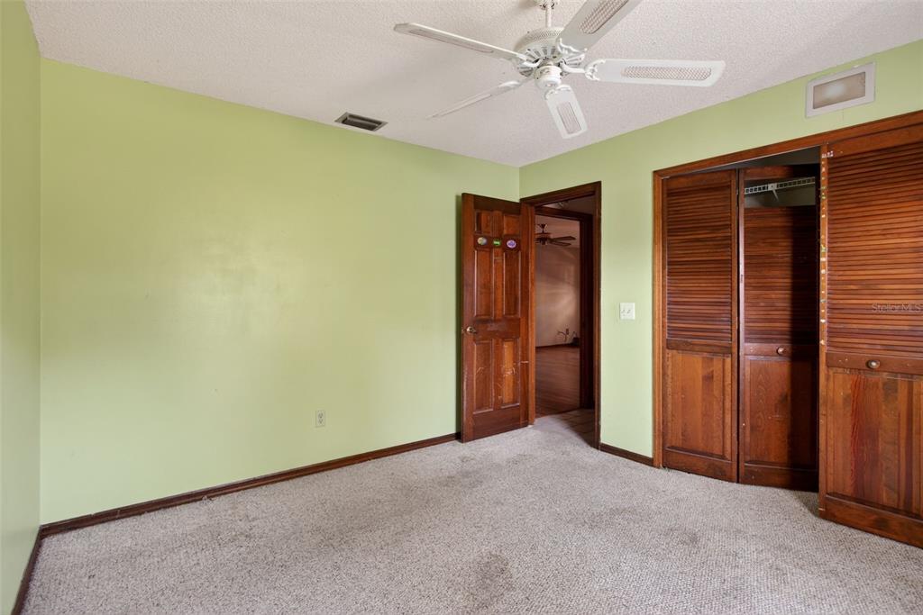 1620 Timbercrest Drive Deltona, FL 32738 - Photo 17 of 28 an empty room with a ceiling fan and closet