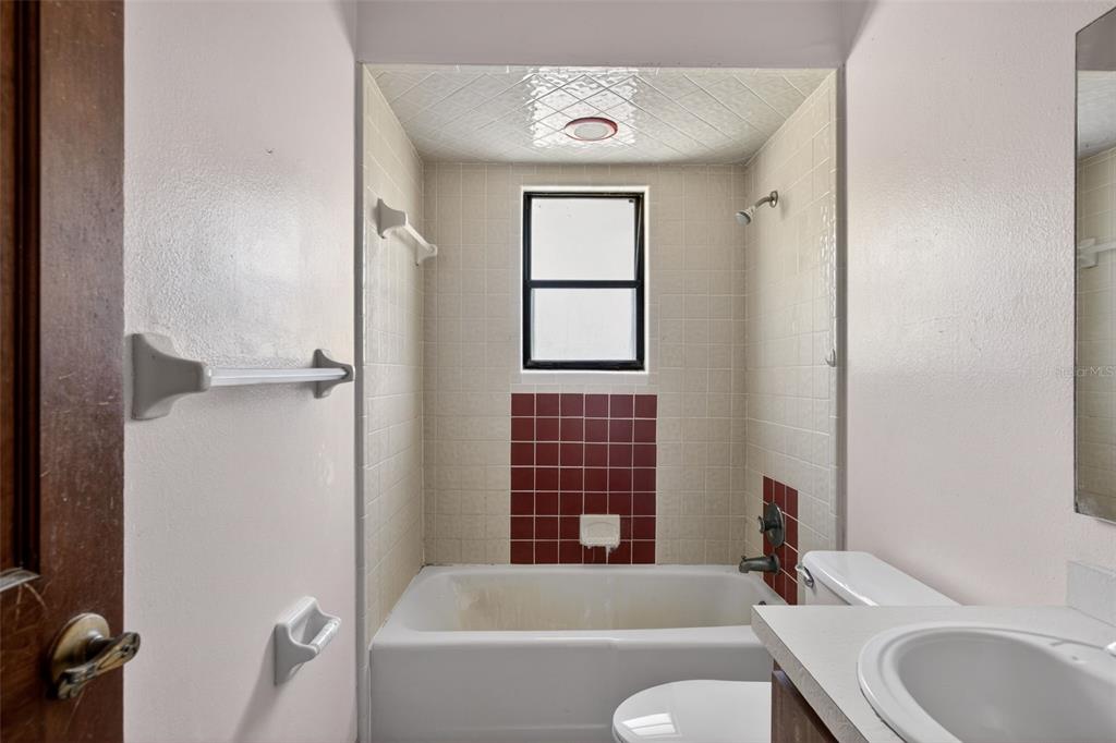 1620 Timbercrest Drive Deltona, FL 32738 - Photo 21 of 28 a bathroom with a granite countertop bathtub shower sink vanity and toilet
