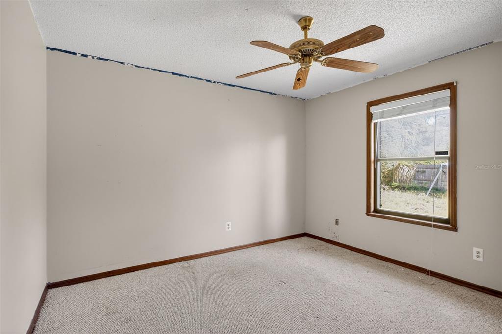 1620 Timbercrest Drive Deltona, FL 32738 - Photo 6 of 28 an empty room with windows and fan