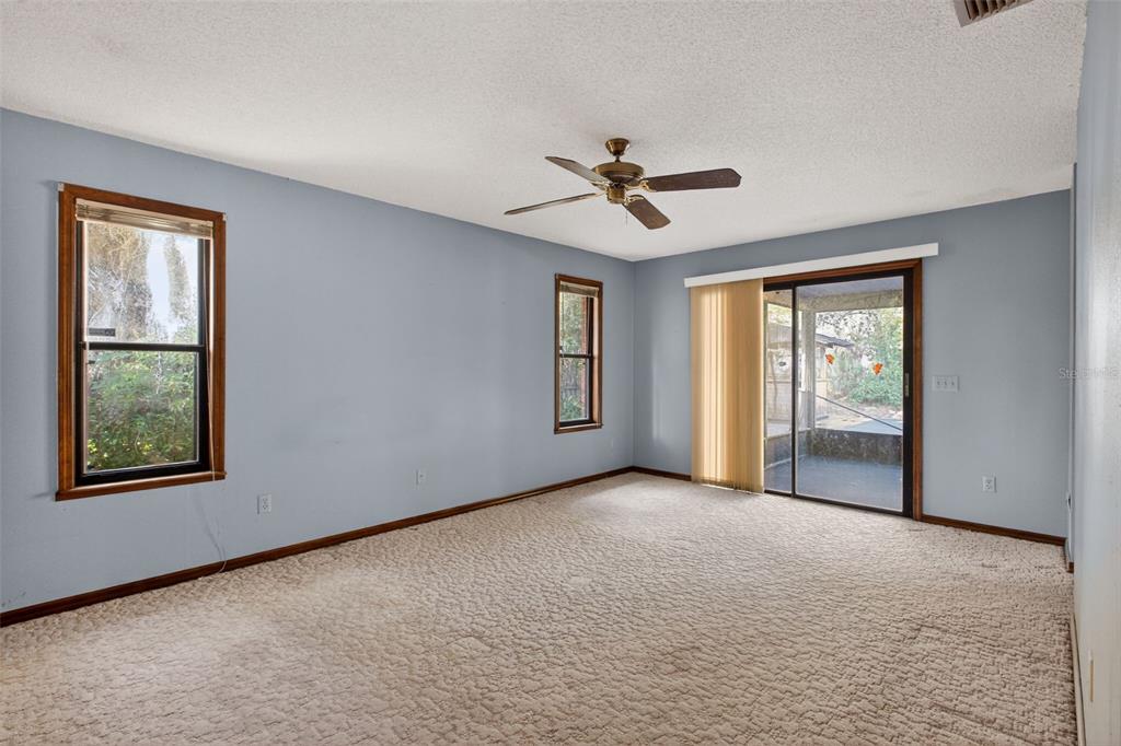 1620 Timbercrest Drive Deltona, FL 32738 - Photo 8 of 28 a view of a big room with windows and chandelier fan