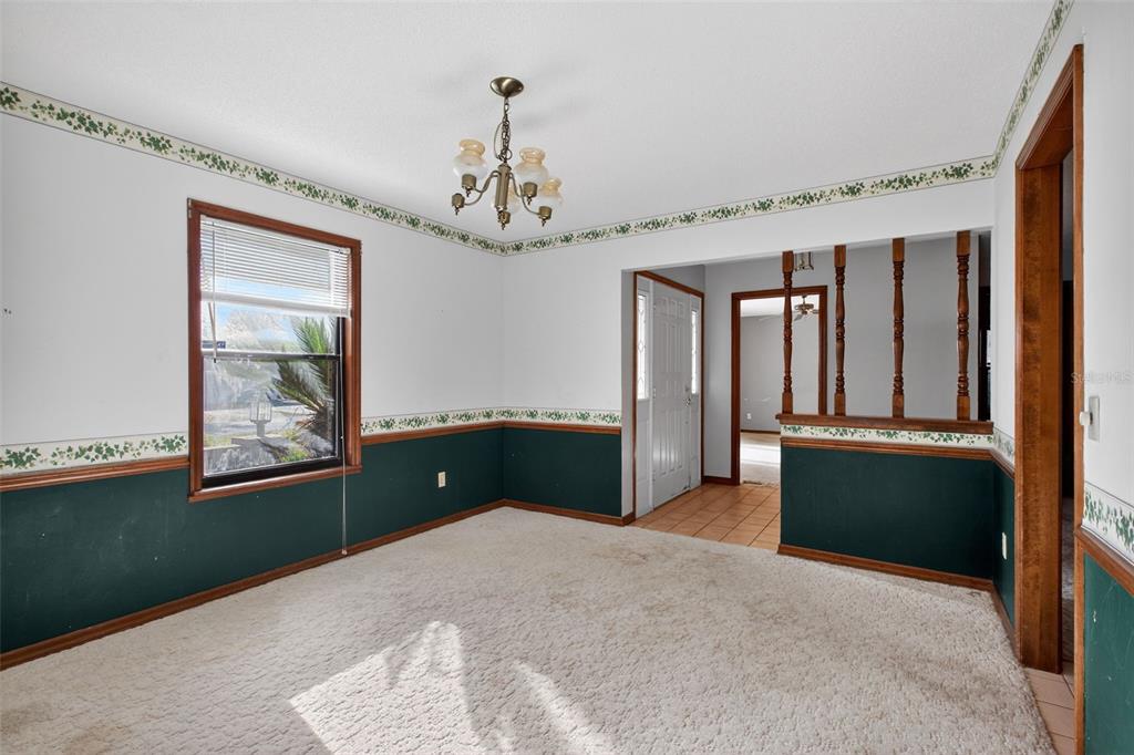 1620 Timbercrest Drive Deltona, FL 32738 - Photo 9 of 28 a bedroom with a large bed and a chandelier