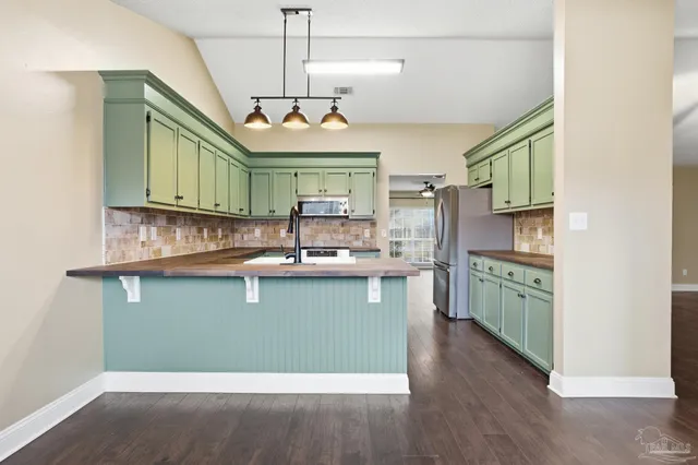 a kitchen with a refrigerator and a sink