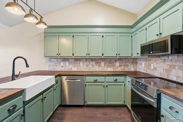 a kitchen with stainless steel appliances granite countertop a sink and a stove