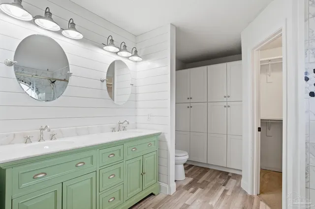 a spacious bathroom with a double vanity sink and mirror