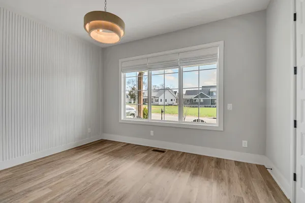 a spacious bedroom with a large bed and a large window