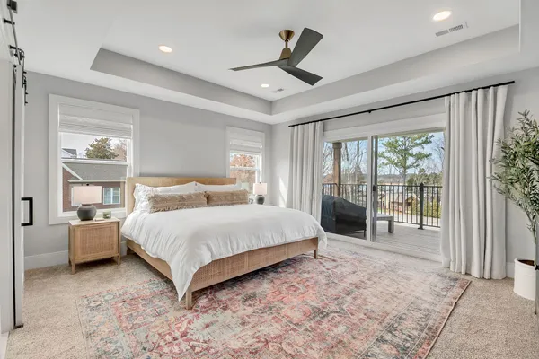 an empty room with fan and windows