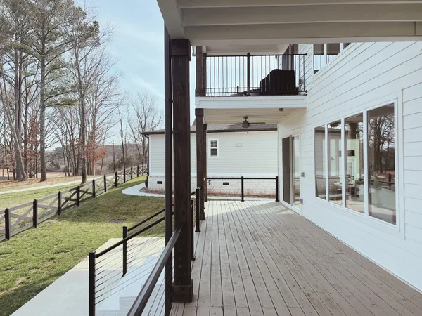 a view of a house with a yard and fence