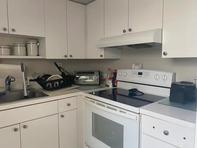 a kitchen with cabinets appliances a sink and a counter top