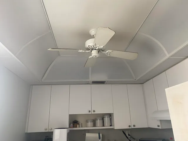 a kitchen with a cabinets and white stainless steel appliances