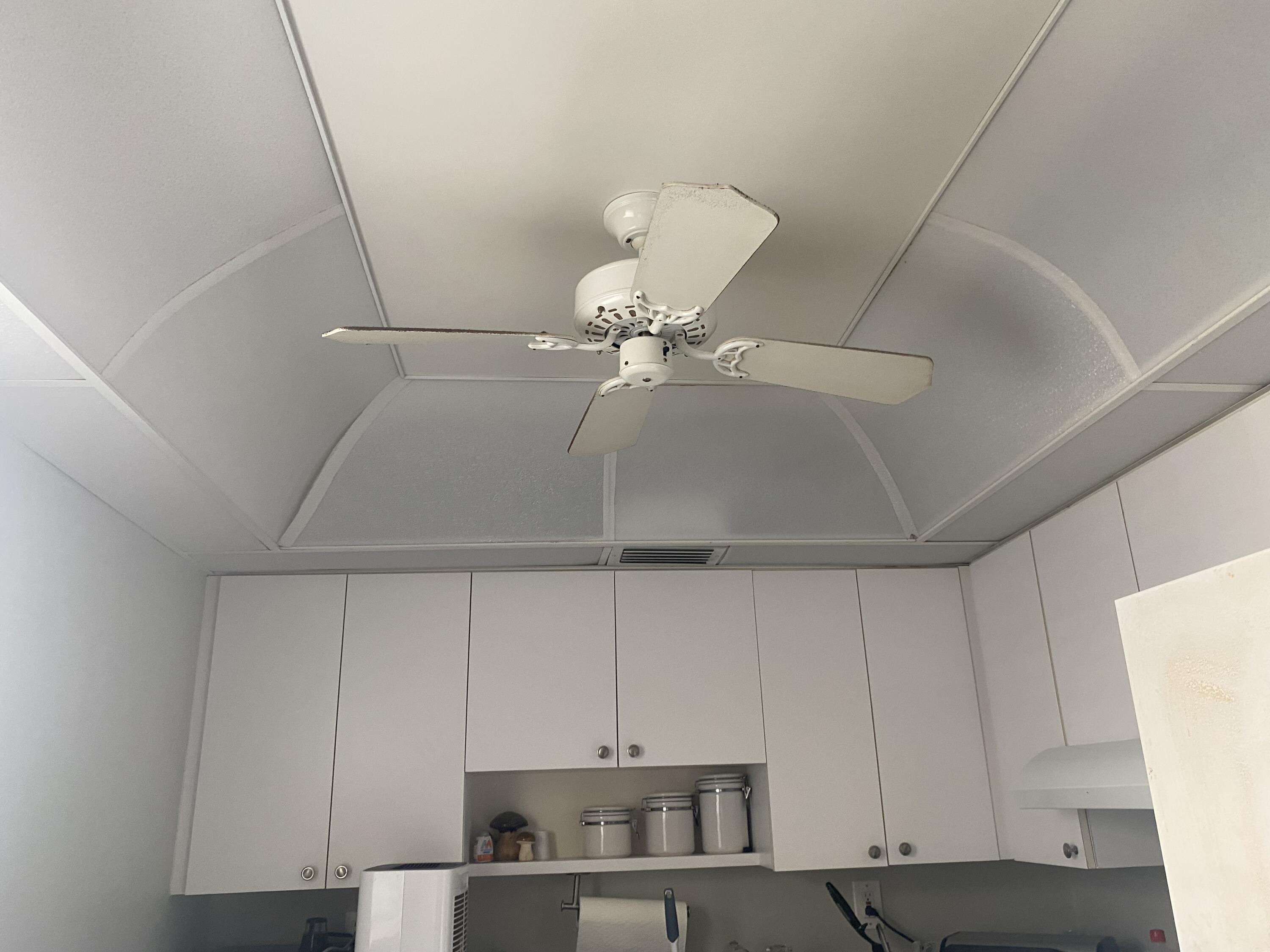 542 Normandy Lane, Unit 542 NORMANDY L Delray Beach, FL 33484 - Photo 12 of 41 a kitchen with a cabinets and white stainless steel appliances