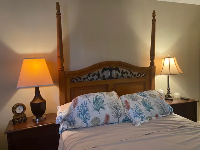 a bedroom with a bed and a lamp