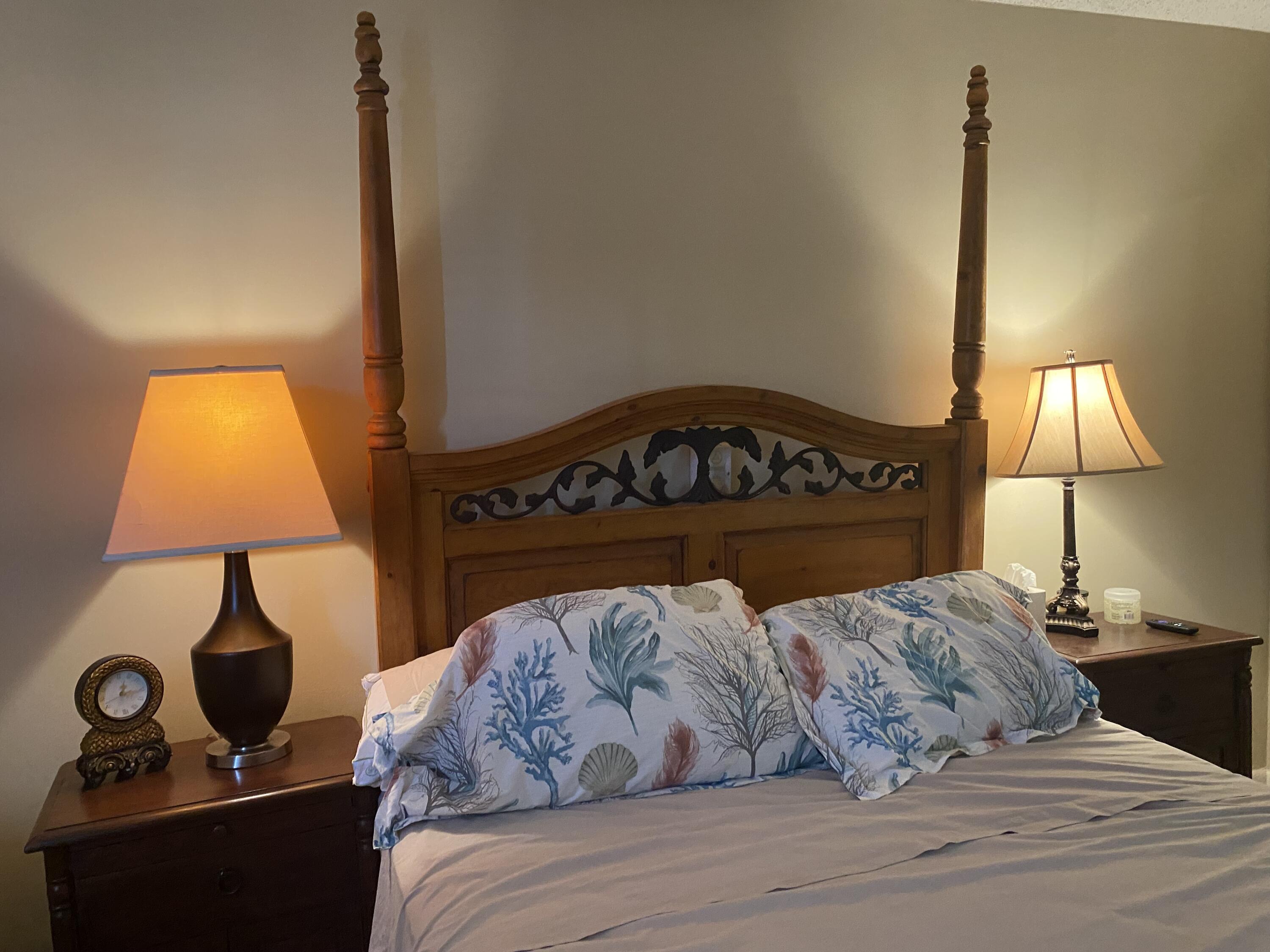 542 Normandy Lane, Unit 542 NORMANDY L Delray Beach, FL 33484 - Photo 22 of 41 a bedroom with a bed and a lamp