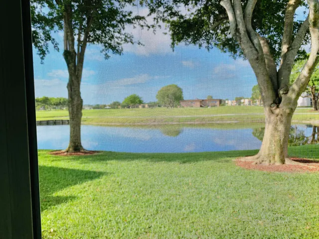 a view of yard with swimming pool and trees