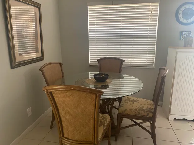 a view of a room with a table and chairs
