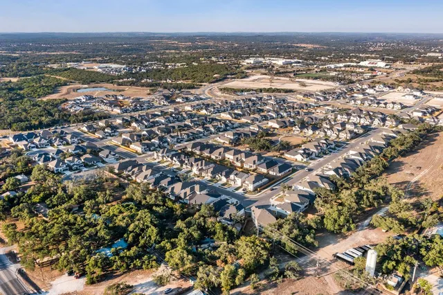 an aerial view of residential building and ocean