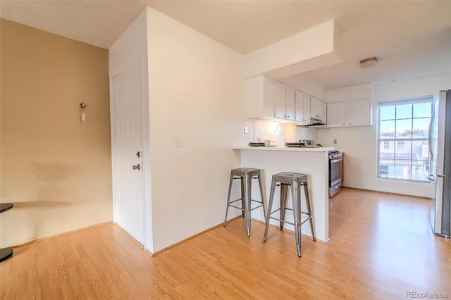 a view of kitchen with granite countertop cabinets and wooden floor