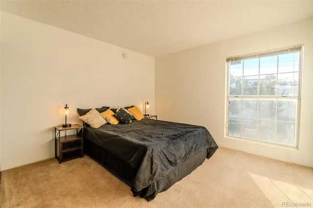 a bed sitting in a room next to a window