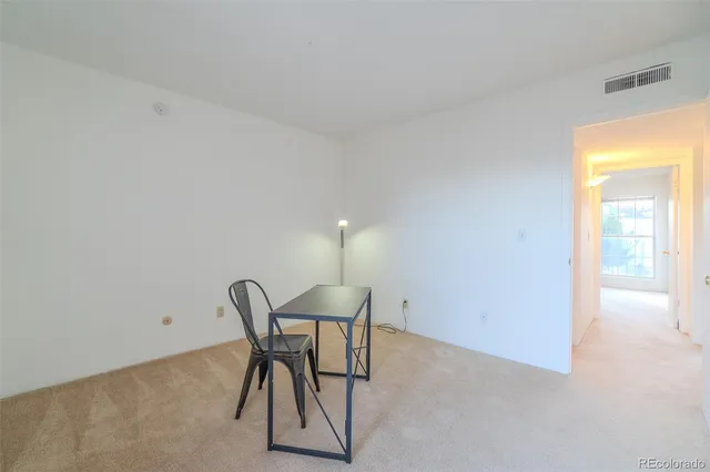 a view of a room with furniture and wooden floor