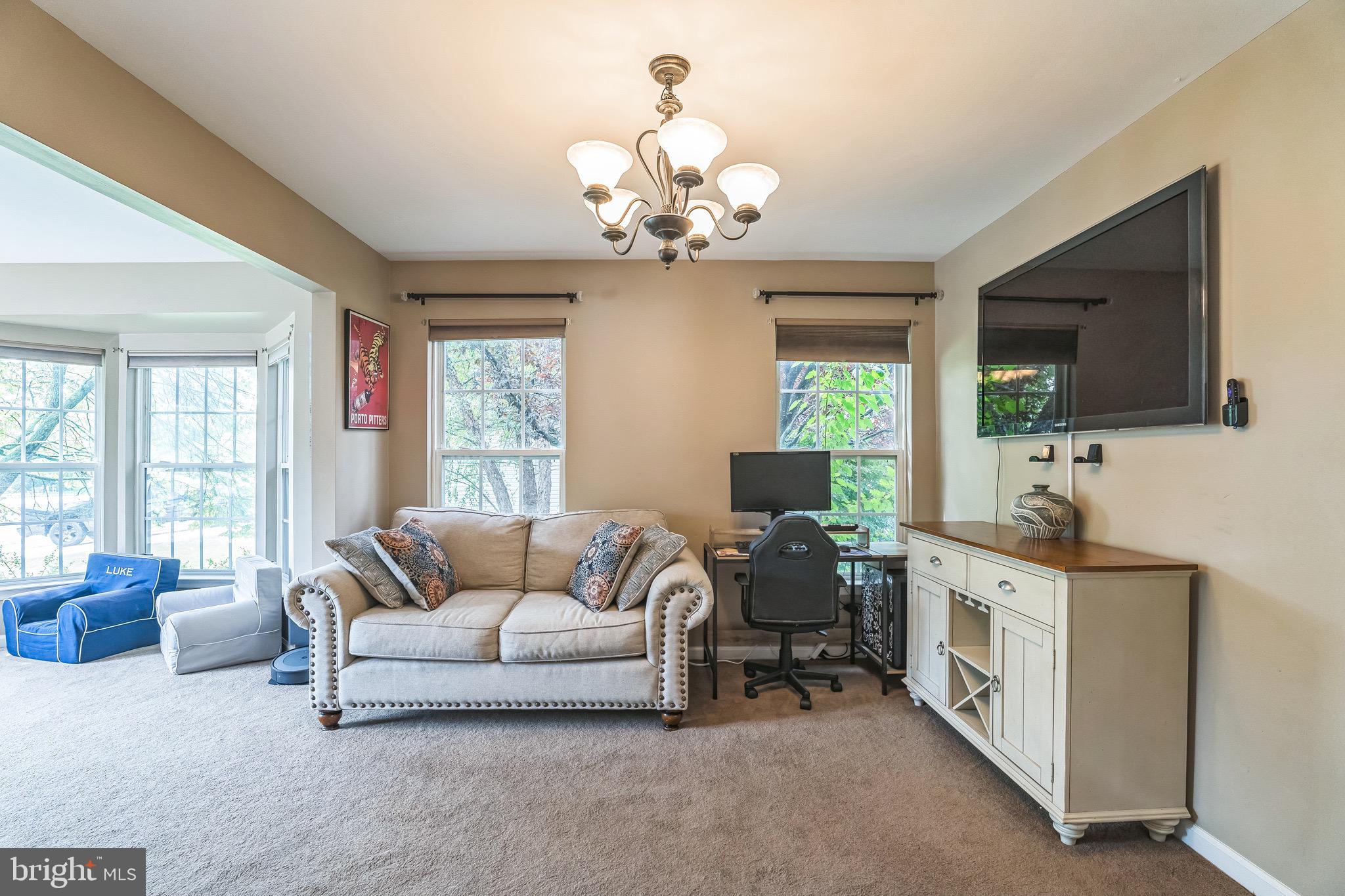 112 Lantern Way Deptford, NJ 08096 - Photo 4 of 30 a living room with furniture chandelier and a flat screen tv