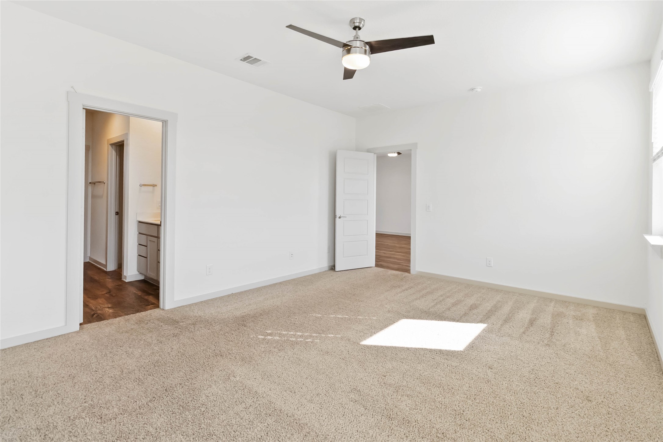217 Deserti Road Leander, TX 78641 - Photo 13 of 31 Unfurnished bedroom with carpet flooring, a ceiling fan, and ensuite bathroom