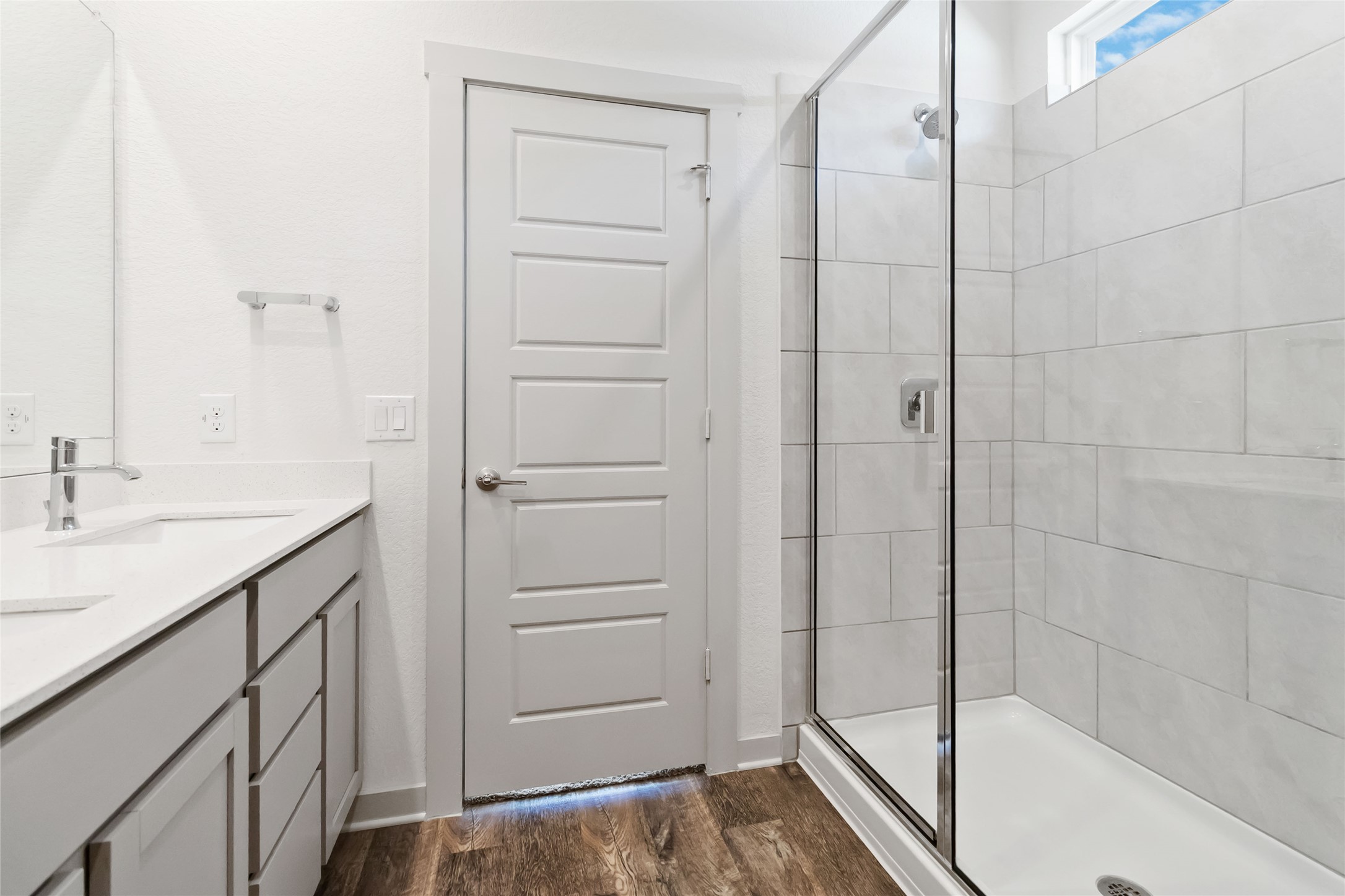 217 Deserti Road Leander, TX 78641 - Photo 15 of 31 Full bath with a stall shower, double vanity, and dark wood finished floors
