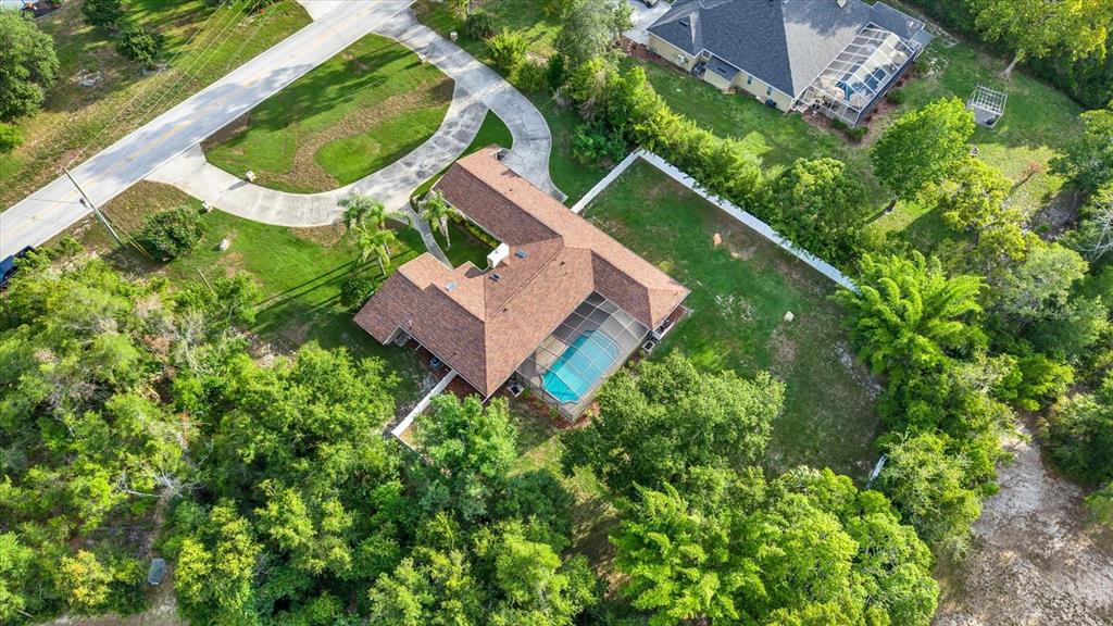 7487 River Country Drive Weeki Wachee, FL 34607 - Photo 52 of 53 an aerial view of a house with a yard and green space