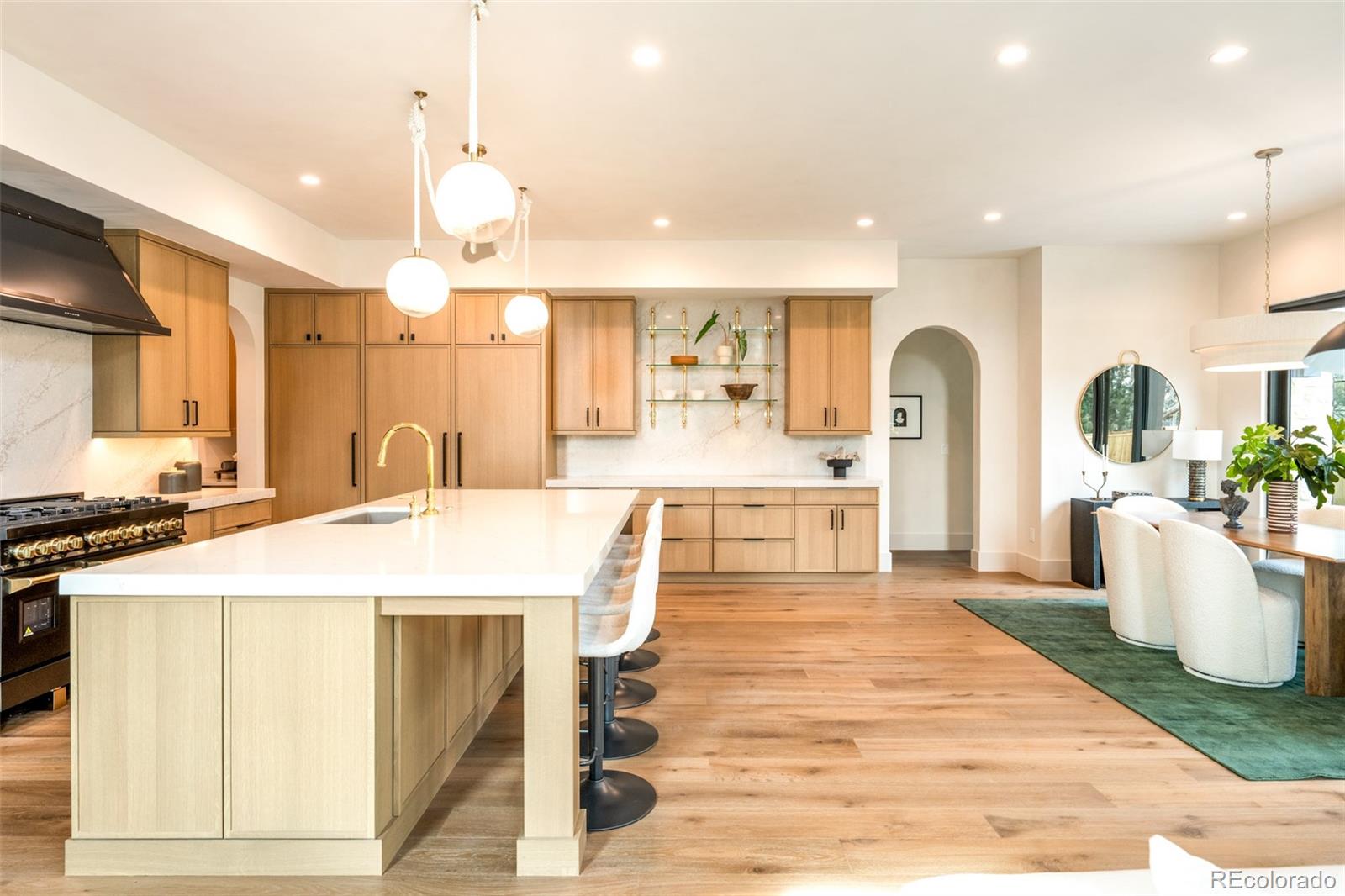 404 Kearney Street Denver, CO 80220 - Photo 13 of 44 a large room with kitchen island a sink and a stove