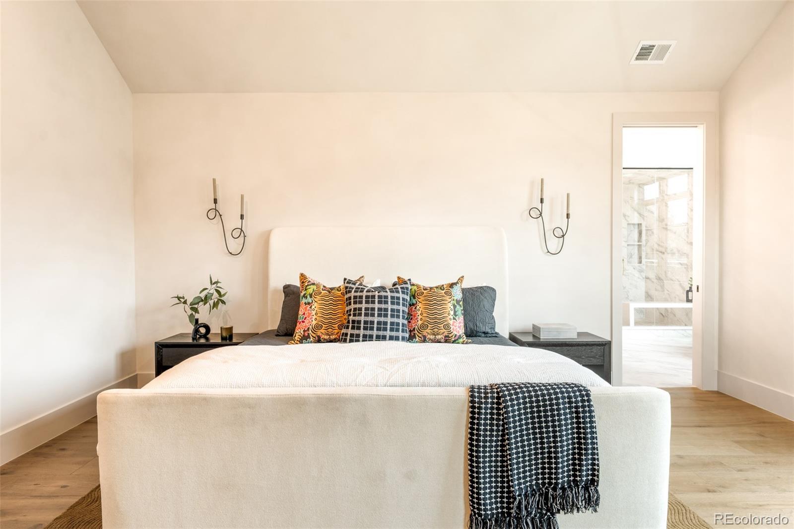 404 Kearney Street Denver, CO 80220 - Photo 22 of 44 a bedroom with a bed and wooden floor