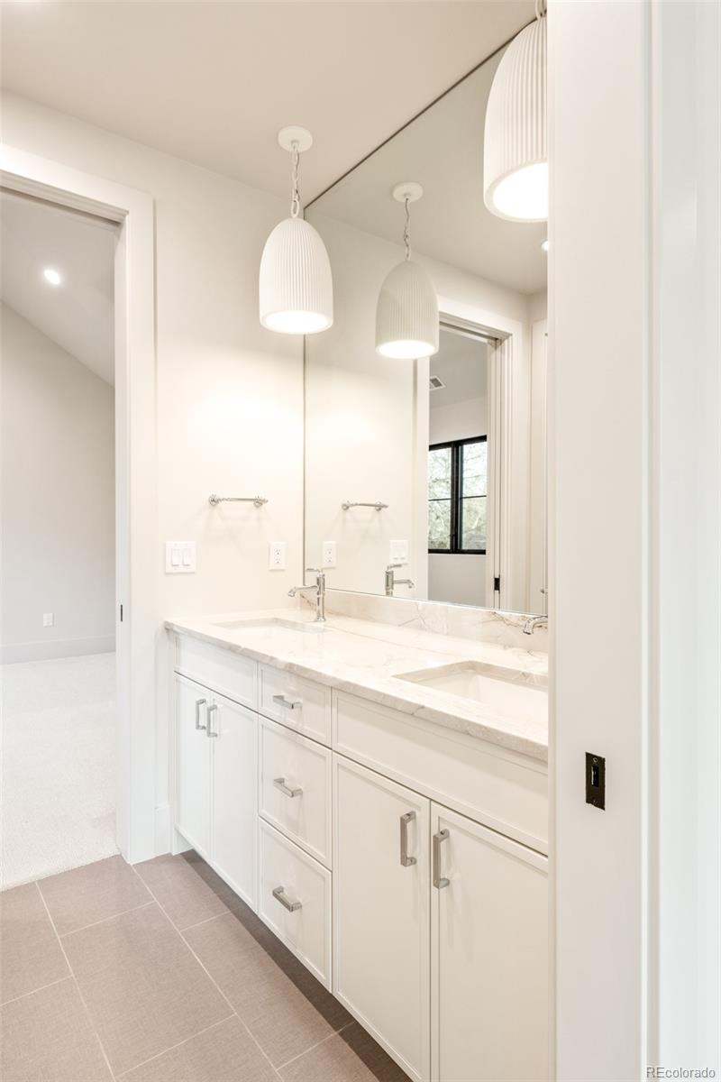 404 Kearney Street Denver, CO 80220 - Photo 28 of 44 a bathroom with a sink and a mirror