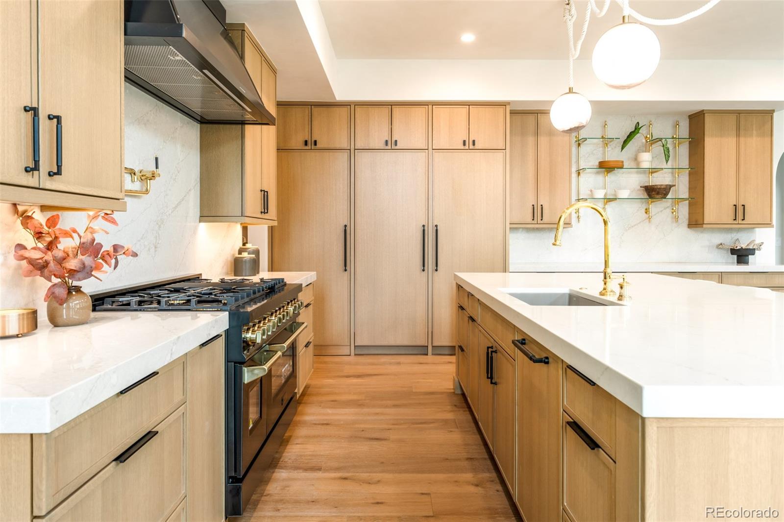 404 Kearney Street Denver, CO 80220 - Photo 9 of 44 a kitchen with stainless steel appliances granite countertop a sink and a stove