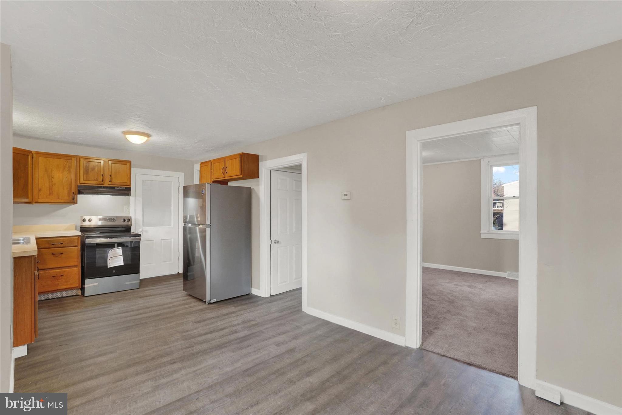 1953 Craley Road Windsor, PA 17366 - Photo 6 of 28 a view of a kitchen with a refrigerator a stove top oven and cabinets