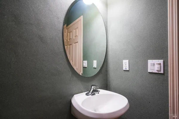 a bathroom with a sink and mirror