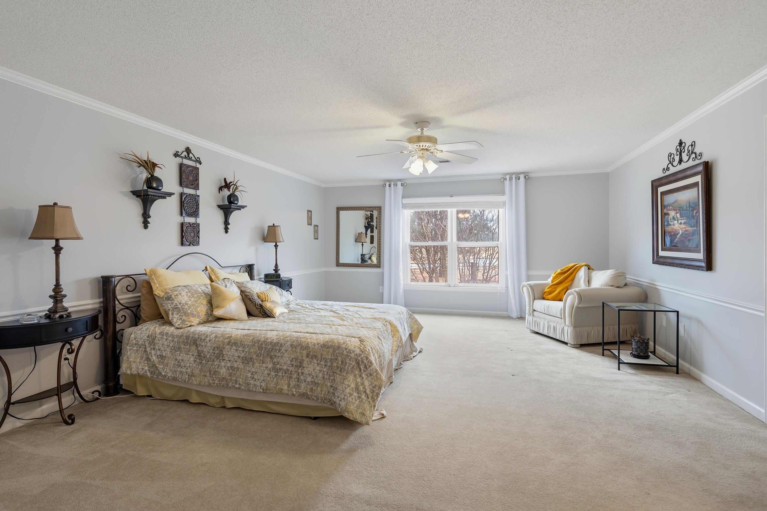 10281 Peyton Path Cove Collierville, TN 38017 - Photo 11 of 40 Carpeted bedroom featuring a ceiling fan, crown molding, and a textured ceiling