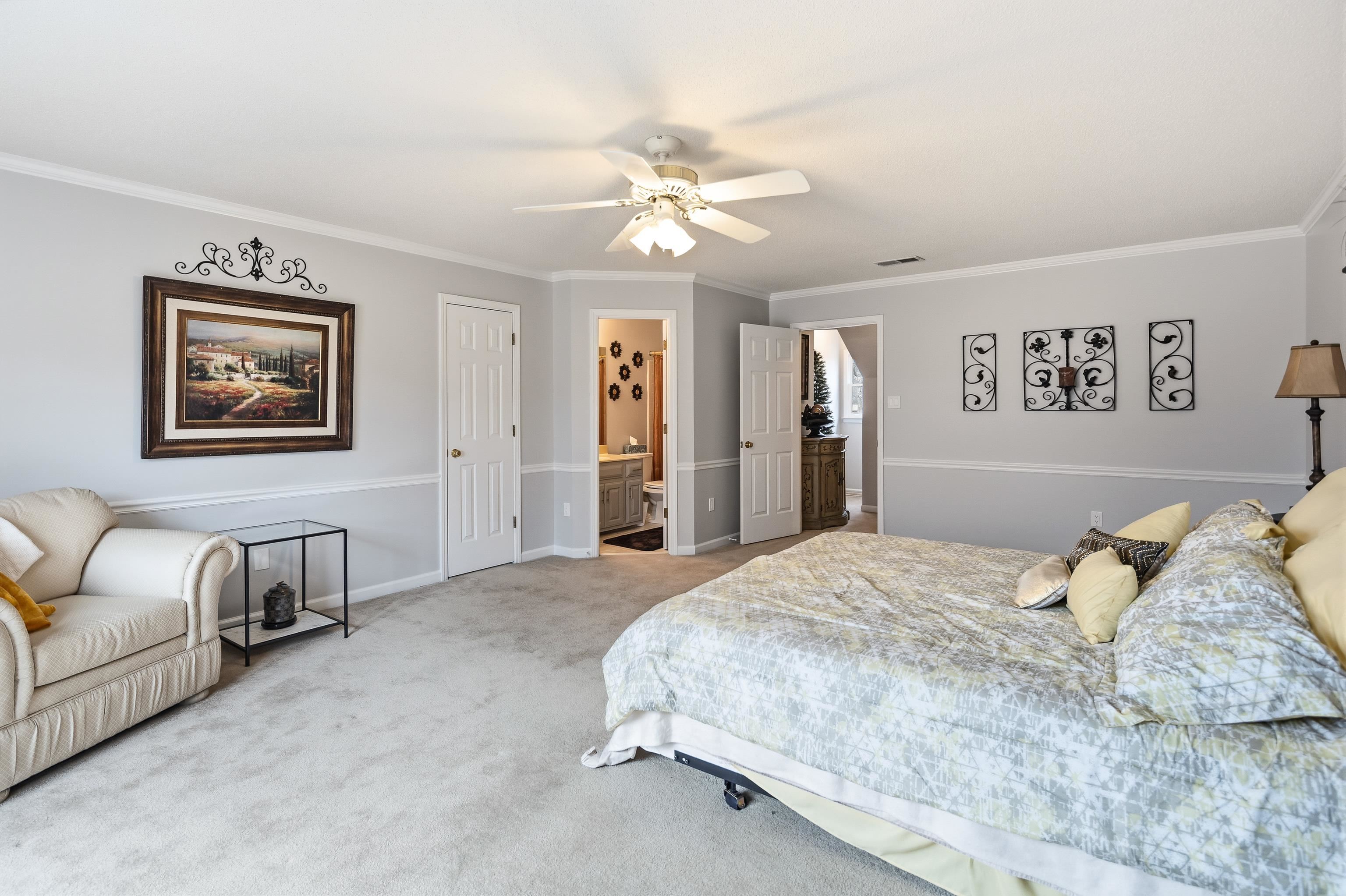 10281 Peyton Path Cove Collierville, TN 38017 - Photo 12 of 40 Carpeted bedroom with crown molding, a closet, a ceiling fan, and connected bathroom