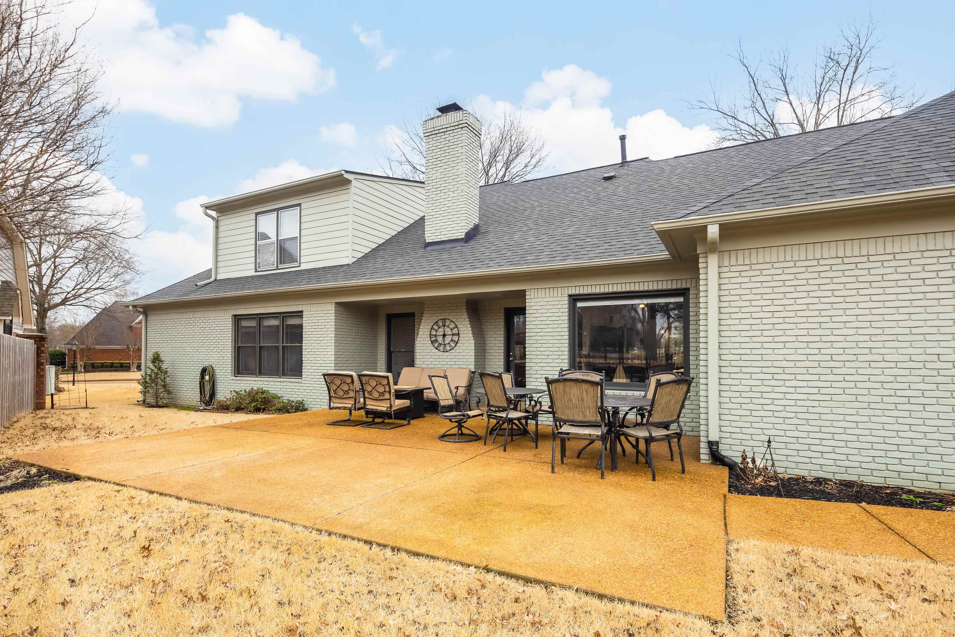 10281 Peyton Path Cove Collierville, TN 38017 - Photo 16 of 40 Rear view of house featuring a chimney, a patio, brick siding, and roof with shingles